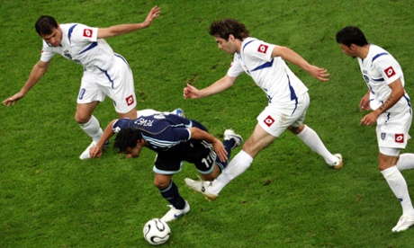 Serbian and Montenegro's Dejan Stankovic, Ivan Ergic and Mateja Kezman try to stop Argentina's Carlos Tevez at the 2006 World Cup.
