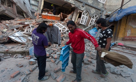 People search near a collapsed house in Kathmandu after another powerful earthquake.