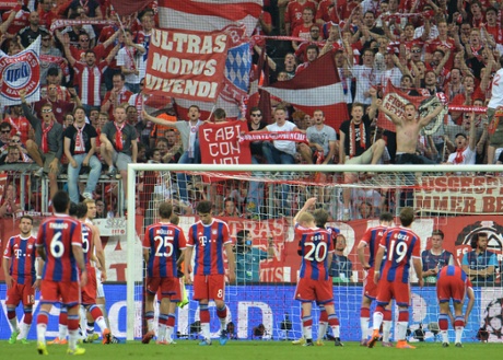 The dejected Bayern players applaud their supporters at the end of the match.