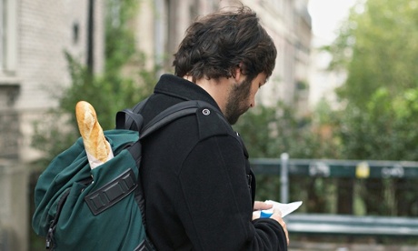 Man carrying baguette in backpack