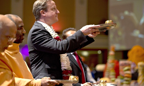 David Cameron takes part in a ceremony at a Hindu temple