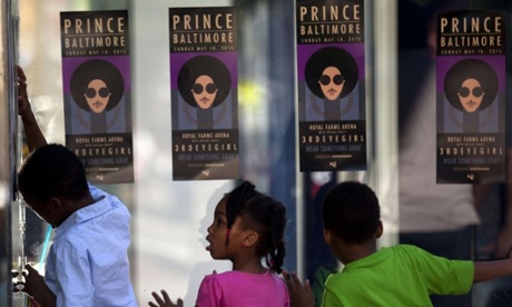 Children look through glass as fans of Prince enter the 