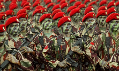 Indonesian soldiers of Special Forces Commandos march during a parade . The military is insisting all female recruits have virginity tests.
