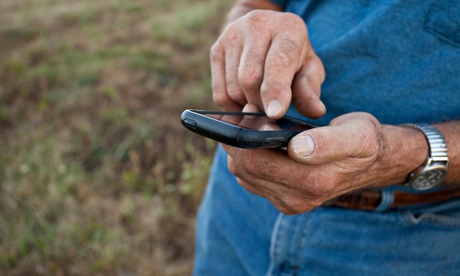 An older man on holiday using his phone