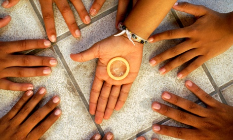 Teens holding a condom