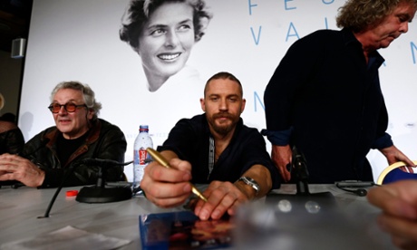Tom Hardy signs autographs during yesterday's press conference for Mad Max: Fury Road.
