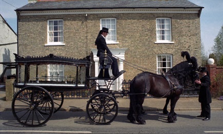 Horse drawn hearse outside a family funeral directors