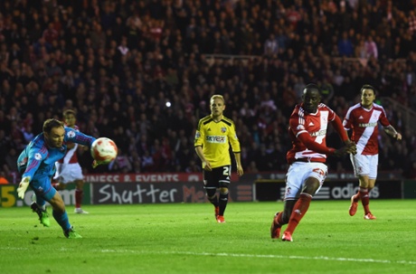 Albert Adomah shoots past goalkeeper David Button to score the third.