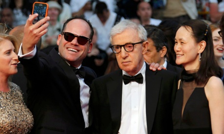 An eager fan takes a selfie with Woody Allen.