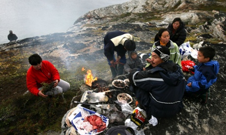 An Inuit fisherman and his family have a seal meat barbecue in Greenland.