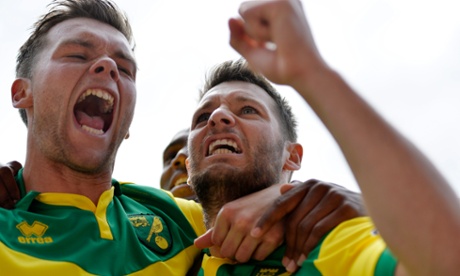 Wes Hoolahan celebrates with team mates after scoring the first goal for Norwich from the penalty spot.