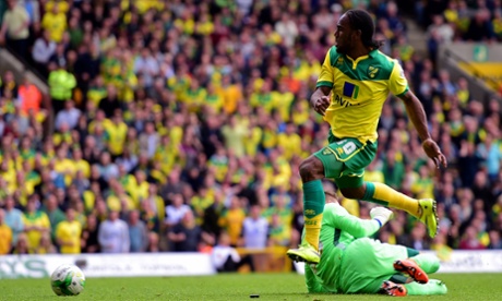 Cameron Jerome scores Norwich's third goal past Ipswich goalkeeper Bartosz Bialkowski.
