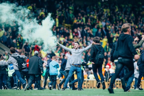 Joyous Norwich fans invade the pitch as they celebrate the win which means they're heading to Wembley for the play-off final.