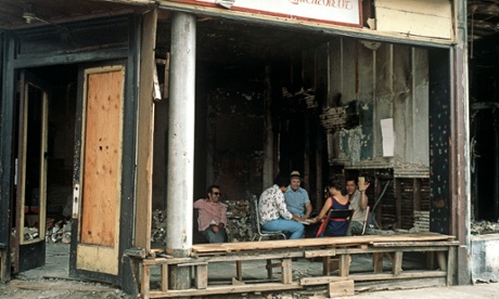 Residents of South Bronx play cards in an abandoned cafe.