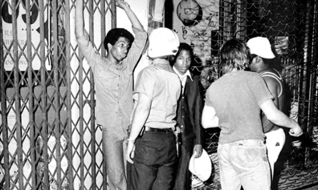 July 1977: during one of the city’s many power failures, police challenge suspected looters in the Bronx.