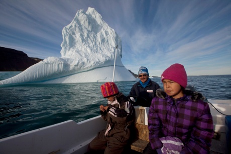 Inuit hunter Nukappi Brandt steers his small boat as he and his daughters scan the water for seals.