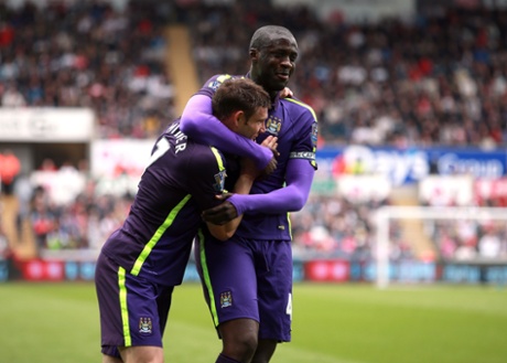 Yaya Toure celebrates with James Milner.