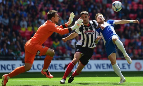 Matt Taylor of Bristol Rovers challenges for the ball with goalkeeper James McKeown and Shaun Pearson of Grimsby Town.