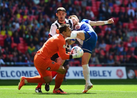 Matt Taylor challenges for the ball with goalkeeper James McKeown and Shaun Pearson.