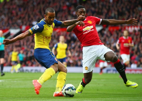 Theo Walcott crosses the ball which deflects off Tyler Blackett.