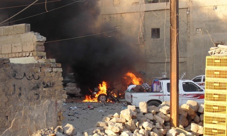 A car is engulfed by flames during clashes in the city of Ramadi.