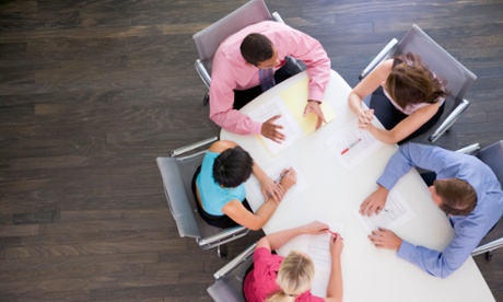 five agency staff sit at a table.