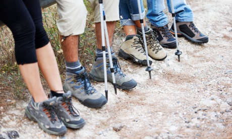 A collection of walkers' feet with walking boots and walking poles