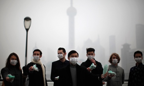 People distributing face masks to pedestrians to raise awareness of air pollution in Shanghai.