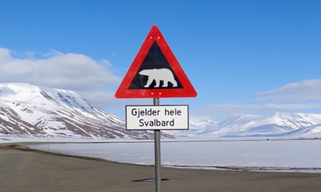 A sign warns residents of the arctic Svalbard islands in Norway of the danger from roaming polar bears, May 26, 2013. The high Arctic, once the irresistible frontier for oil and gas exploration, is quickly losing its appeal as energy firms grow fearful of the financial and public relations risk of working in the pristine icy wilderness.