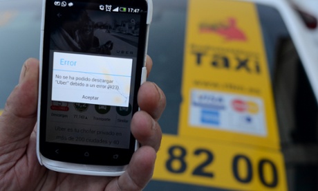 Alcobendas, Spain. 9th December 2014 - A taxi driver holds his mobile phone screen showing an error as he tries to download the 'Uber' application to his smartphone after a judge ordered US-based ride-sharing and taxi service Uber to cease all activities in Spain.