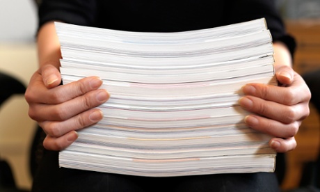 woman holding stack of paper