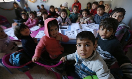 Syrian children attend a class at a school for refugees in the Lebanese village of Qaraoun, in the Bekaa Valley.