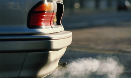 Car exhaust emitting grey smoke, close-up