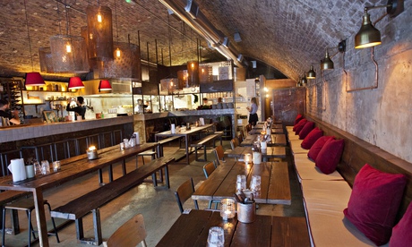 The brick-vaulted-ceiling and banquette and benches at Berber & Q