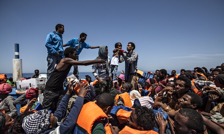 Migrants wait aboard a boat during a rescue operation in partnership with Doctors Without Borders off the coast of Sicily