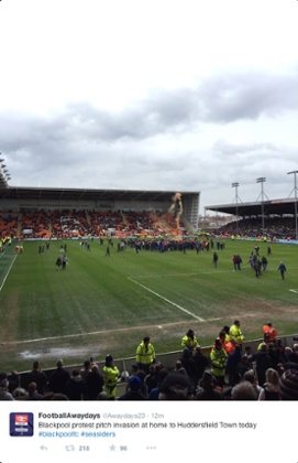 Blackpool fans protest on the pitch against Huddersfield 