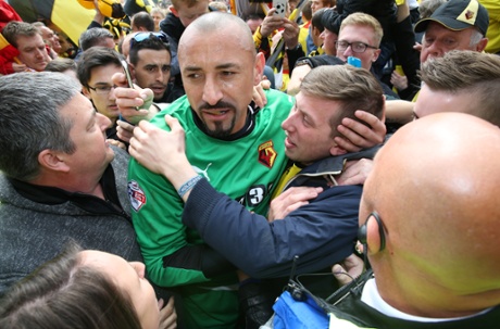 Watford keeper Heurelho Gomes is hugged by fans as he attempts to head back to the dressing room after the final whistle.