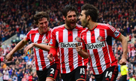 Jordi Gomez, right, celebrates with Danny Graham, centre, and Billy Jones after slotting home his penalty