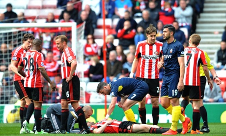 Shane Long checks on John O'Shea after the Sunderland player got a knock to the head in a challenge with Long.