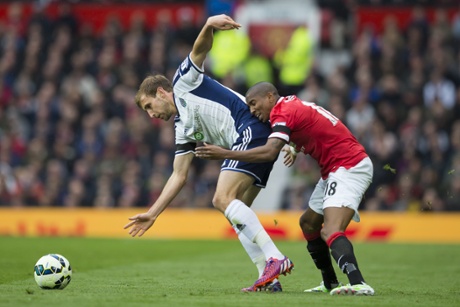 Manchester United's Ashley Young, right, fights for the ball against West Bromwich Albion's Craig Dawson.