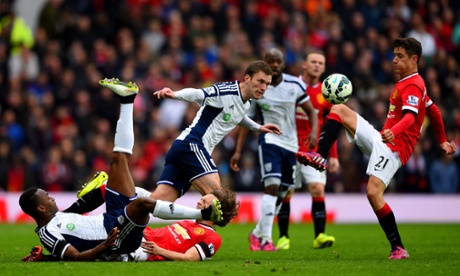 Craig Gardner of West Brom heads the ball clear from Ander Herrera of Manchester United as Saido Berahino lands on Daley Blind of Manchester United