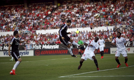 Real Madrid's Cristiano Ronaldo heads the opening goal against Sevilla.