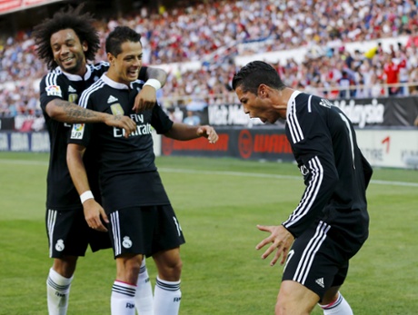 Then celebrates in front of Marcelo, left, and Javier Hernandez