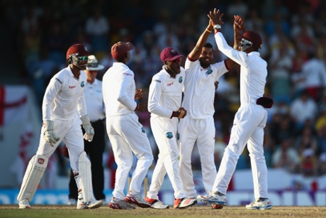 Veerasammy Permaul, second right, celebrates after bowling Moeen Ali.