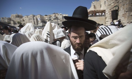 Jewish men draped in prayer shawls perform the Cohanim prayer (priest's blessing) during the Pesach (Passover) holiday at the Western Wall in the old city of Jerusalem.