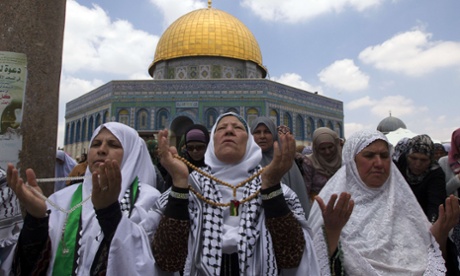 Palestinian women take part in Friday prayers during  Ramadan at Al-Aqsa mosque compound in Jerusalem.