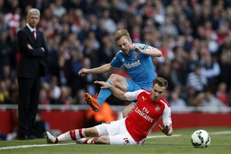 Arsenal's Aaron Ramsey clatters into Sebastian Larsson and leaves him in a heap as well as earning himself a yellow card ...