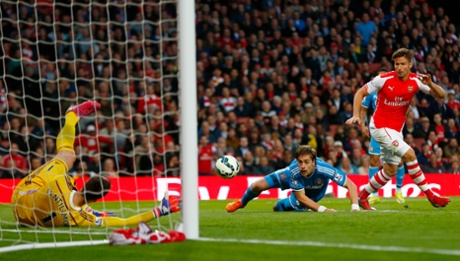 Costel Pantilimon gets down smartly at the near post to deny Arsenal's Olivier Giroud.