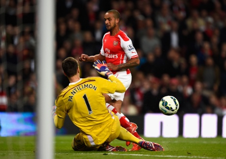 Theo Walcott gets the better of but not Sebastian Coates as the Sunderland defender raced back to clear the ball.
