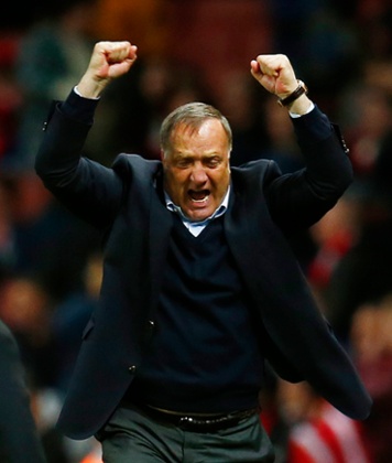 Sunderland manager Dick Advocaat punches the air in delight at masterminding Sunderland’s survival.